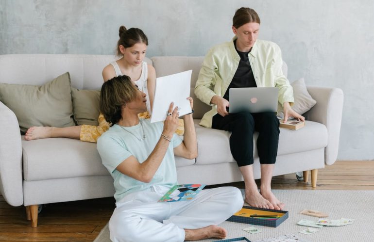 A family of three enjoying togetherness with creative activities in a stylish living room.